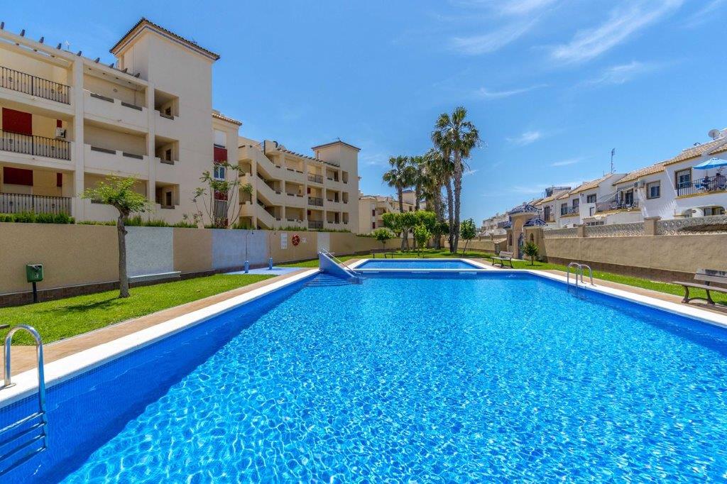 Top floor apartment with 2 bedrooms and 1 bathroom in front of communal pool.
